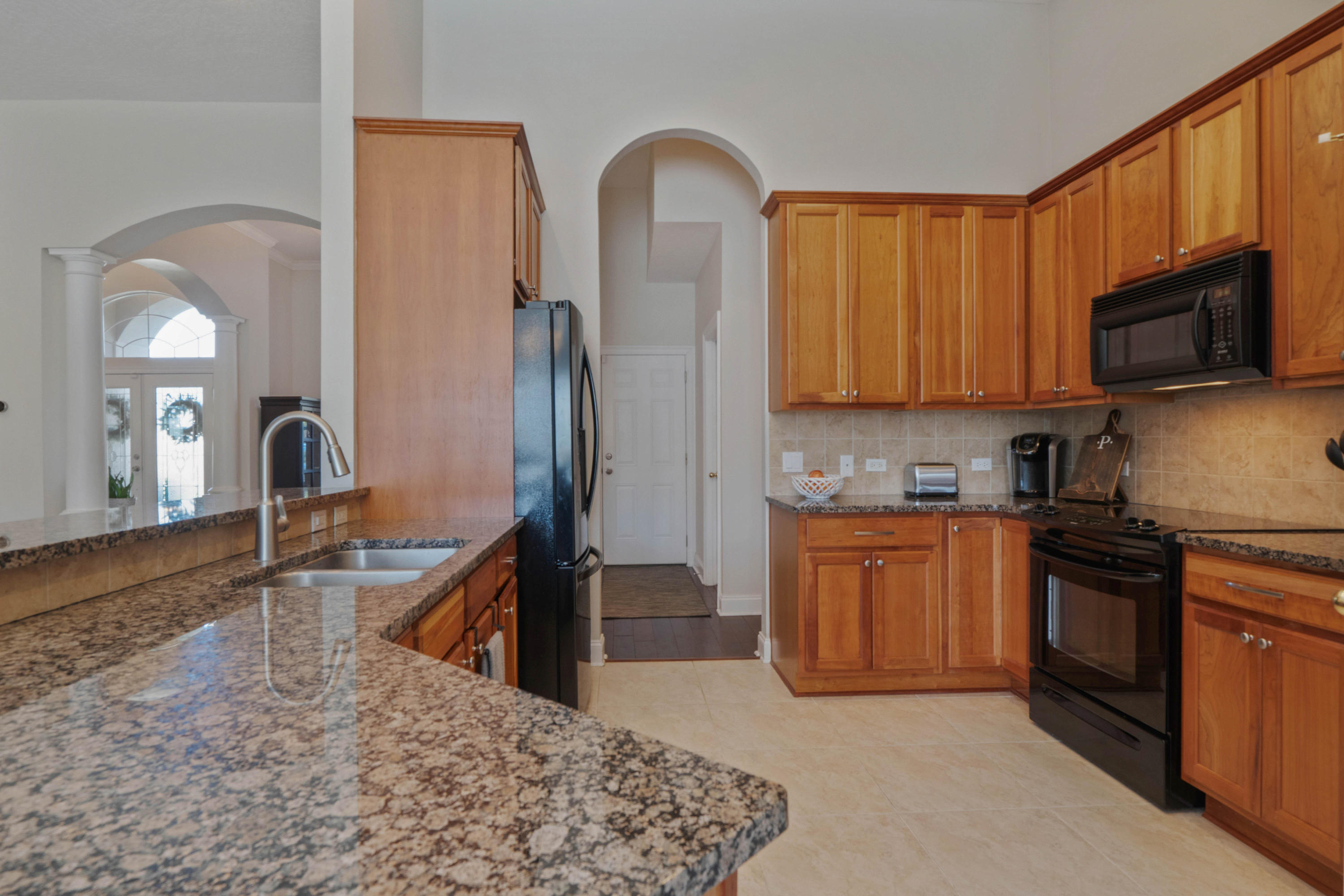 4611 Chanan Drive Crestview, FL 32539 - Photo 17 of 39 a kitchen with stainless steel appliances granite countertop a refrigerator a stove top oven and sink