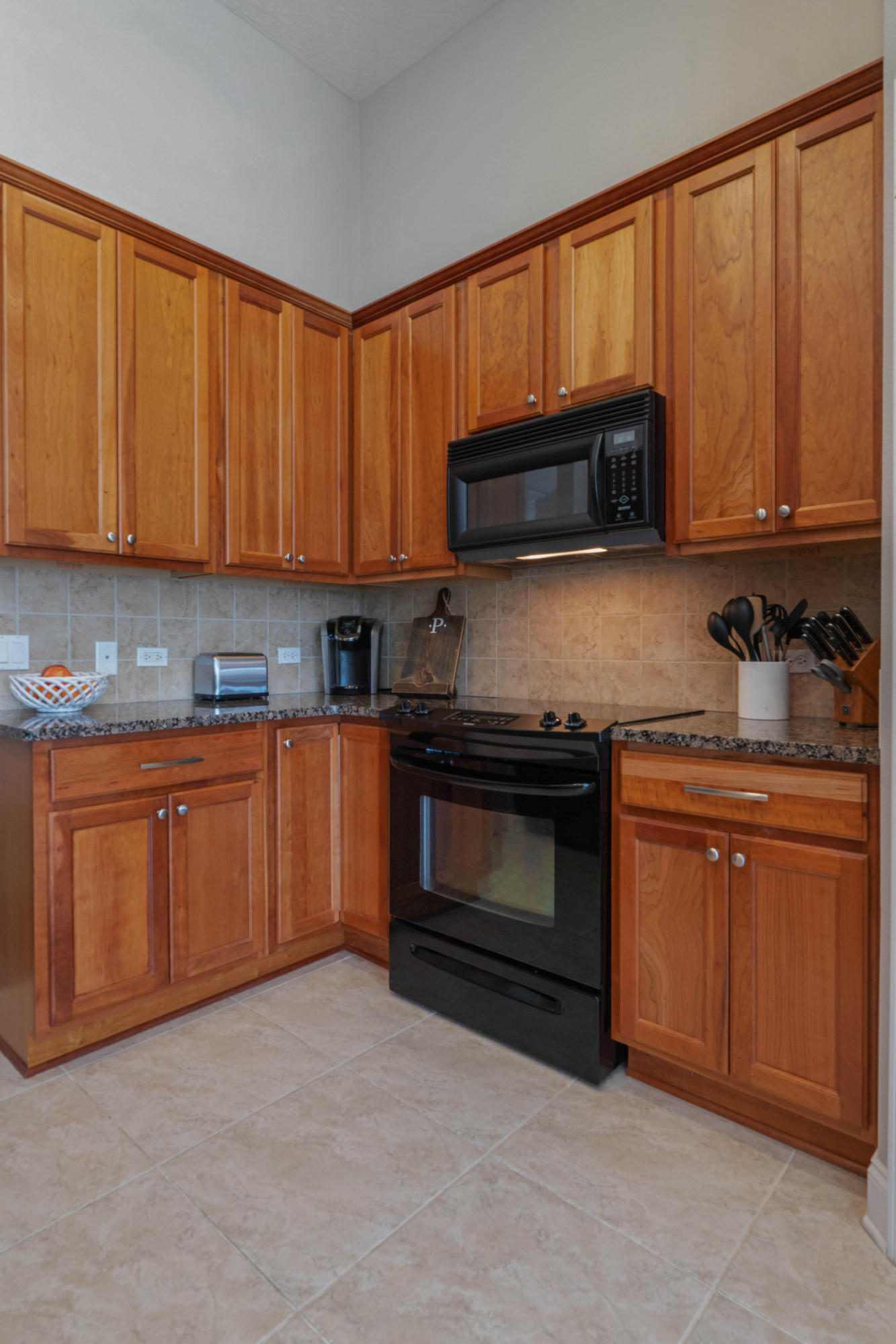 4611 Chanan Drive Crestview, FL 32539 - Photo 18 of 39 a kitchen with granite countertop a stove top oven microwave and cabinets
