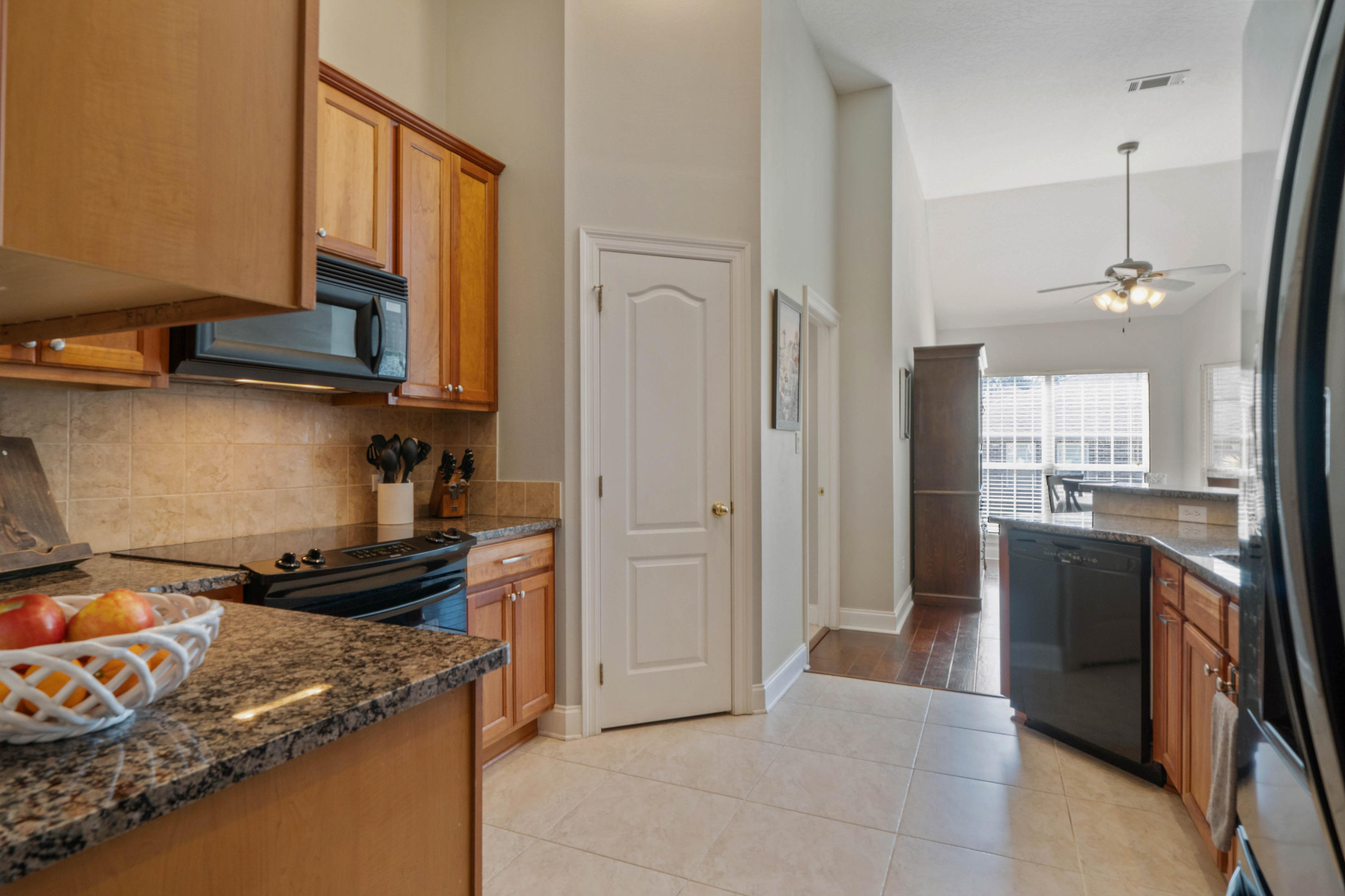4611 Chanan Drive Crestview, FL 32539 - Photo 21 of 39 a kitchen with a refrigerator and a stove top oven