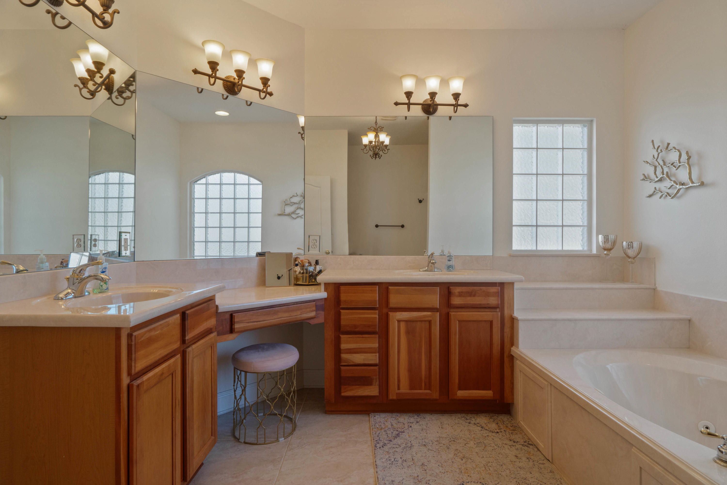 4611 Chanan Drive Crestview, FL 32539 - Photo 24 of 39 a spacious bathroom with a granite countertop double vanity sink a large mirror a toilet a bathtub and vanity