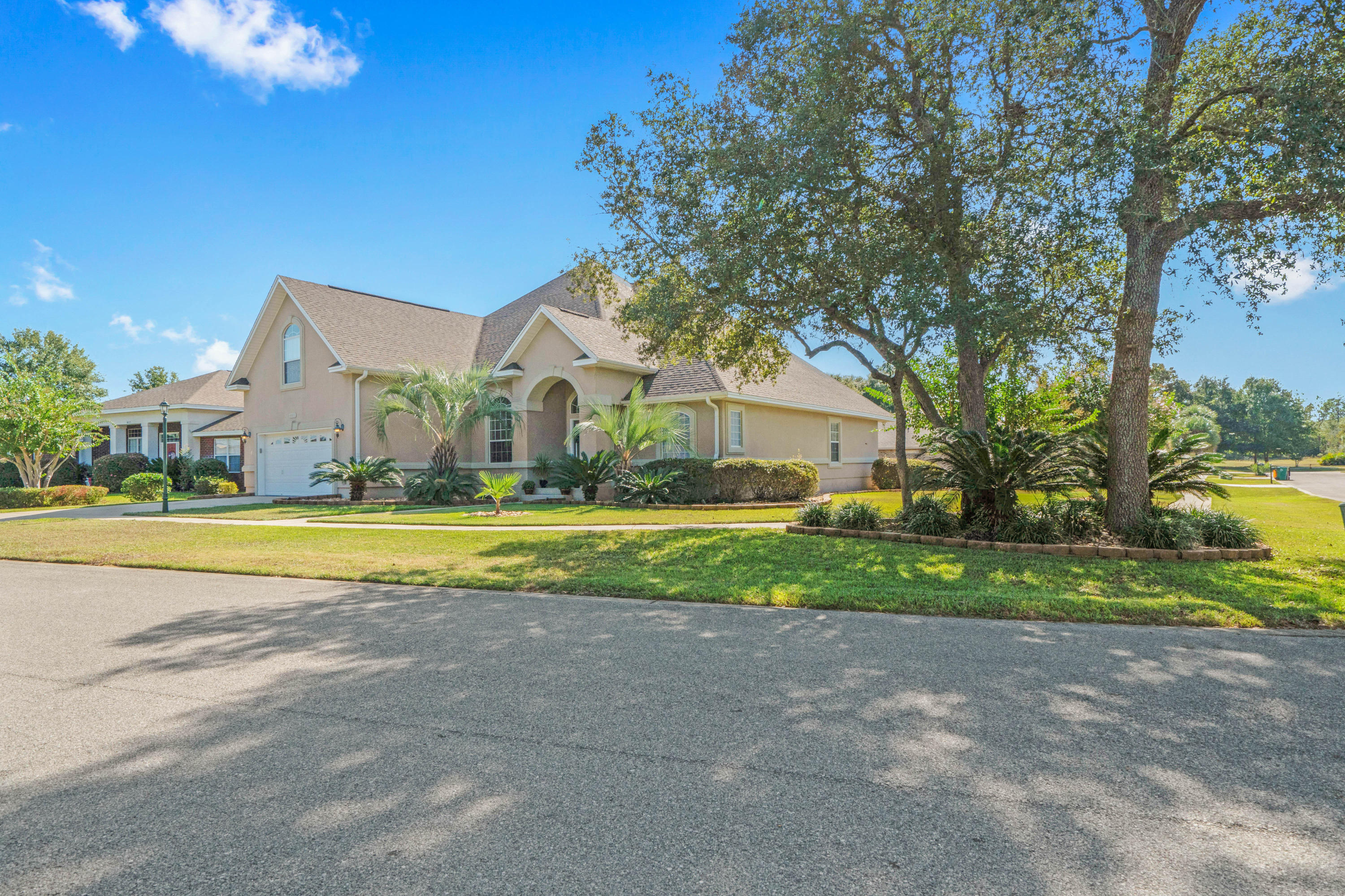 4611 Chanan Drive Crestview, FL 32539 - Photo 3 of 39 a view of house with garden and large trees