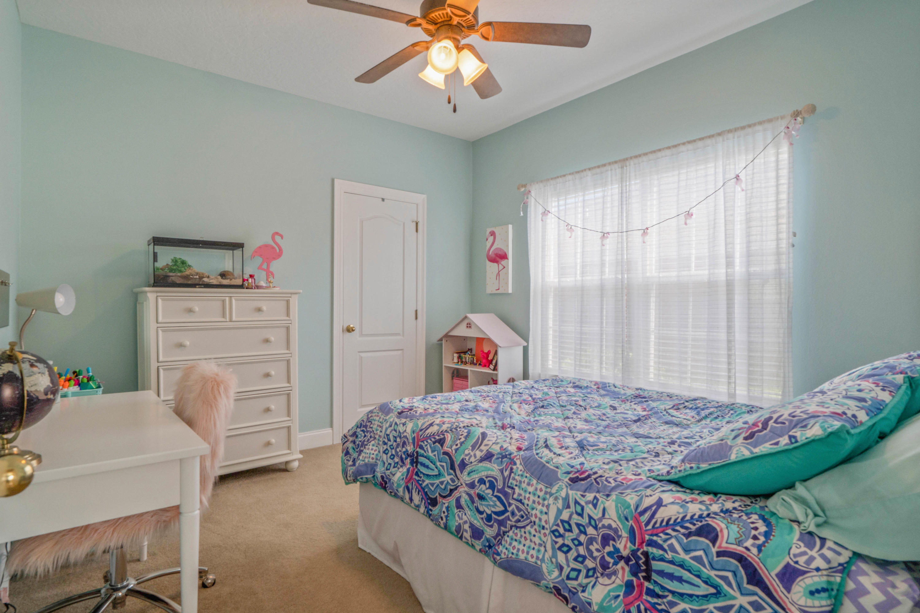 4611 Chanan Drive Crestview, FL 32539 - Photo 31 of 39 a bedroom with a bed and a chandelier