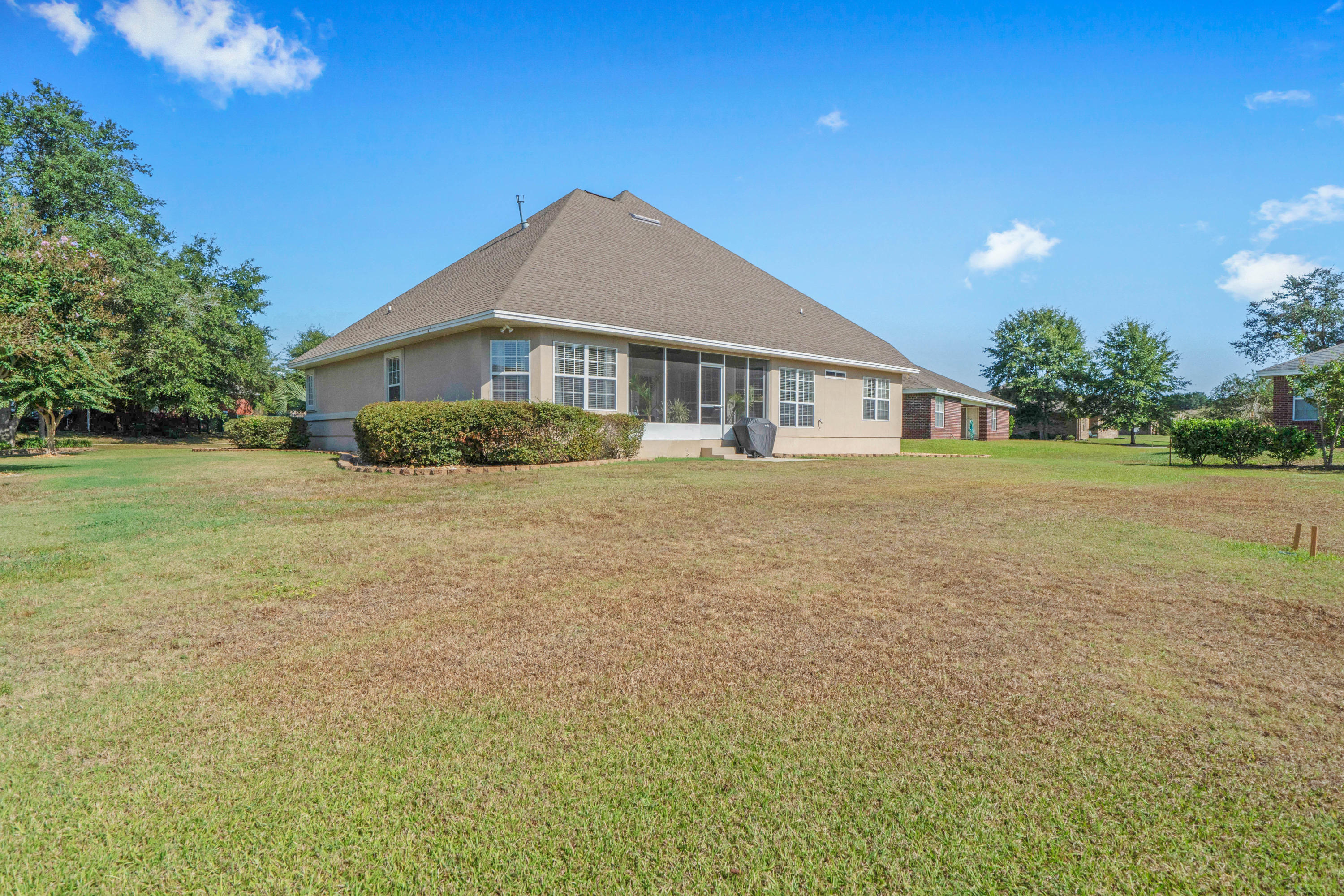 4611 Chanan Drive Crestview, FL 32539 - Photo 5 of 39 a front view of a house with a yard
