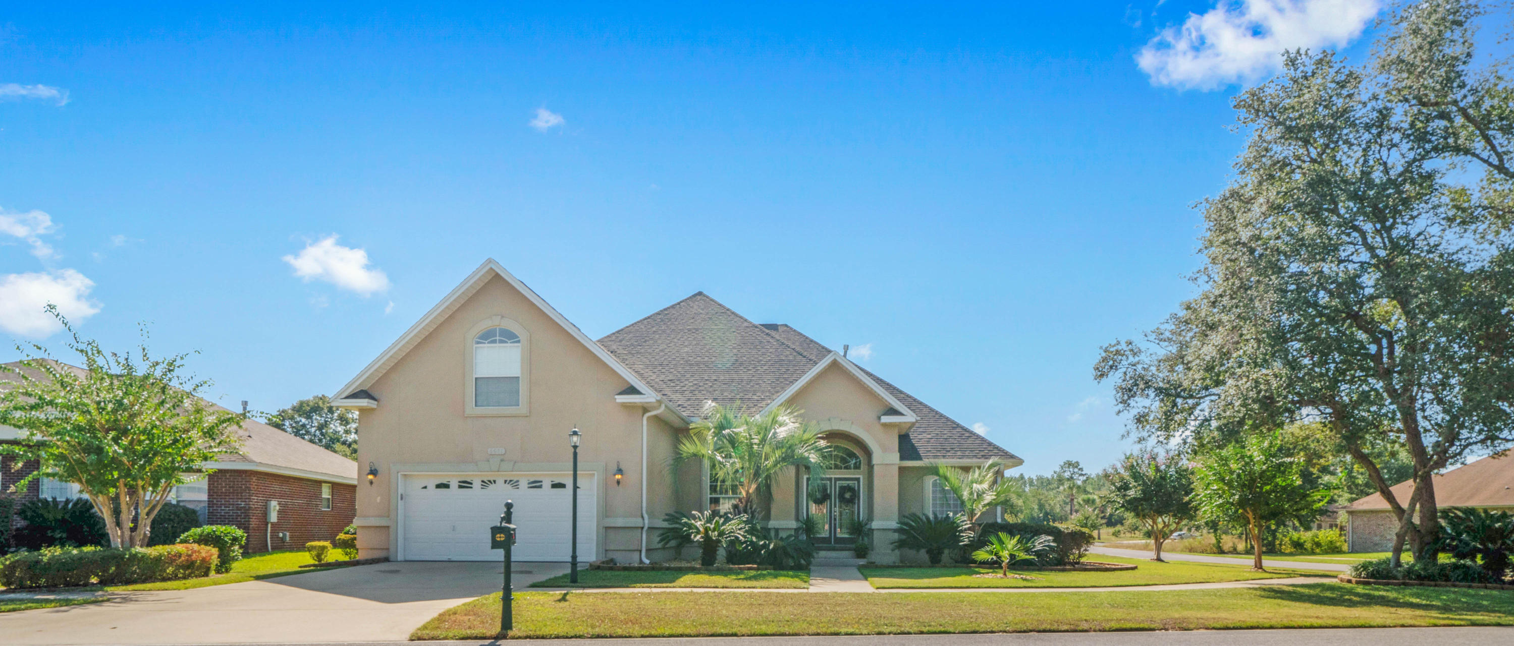 4611 Chanan Drive Crestview, FL 32539 - Photo 6 of 39 a view of a house with a yard and palm trees