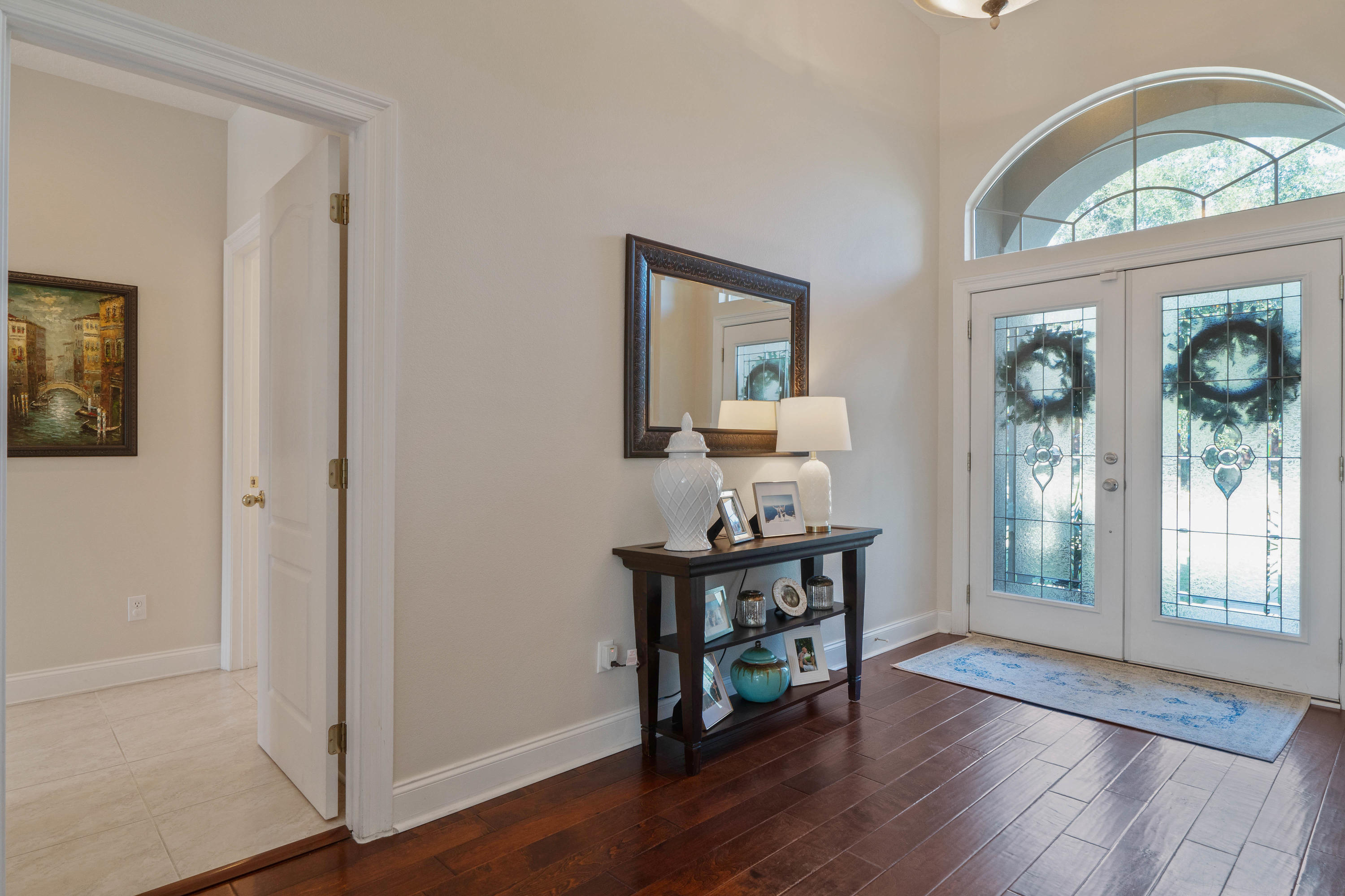 4611 Chanan Drive Crestview, FL 32539 - Photo 8 of 39 a view of an entryway with wooden floor mirror and a window