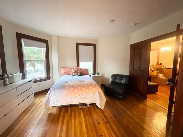 a bedroom with a bed and a large window