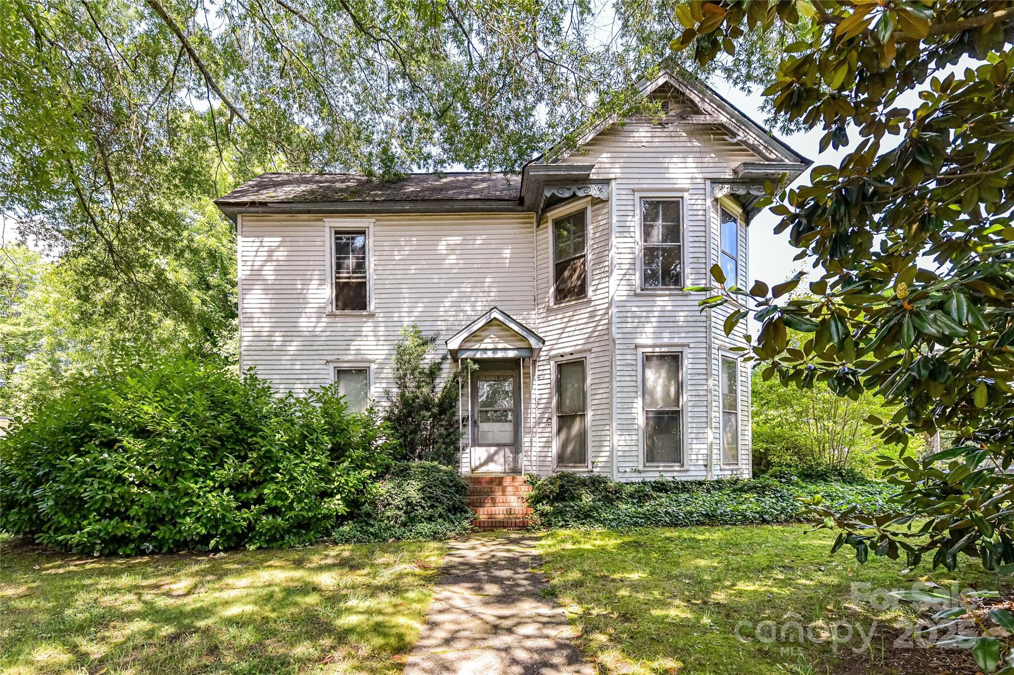 a front view of a house with a garden