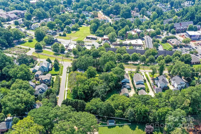 an aerial view of residential houses with outdoor space and swimming pool