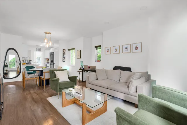 a living room with lots of furniture and a chandelier