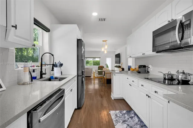 a kitchen with sink a stove and cabinets