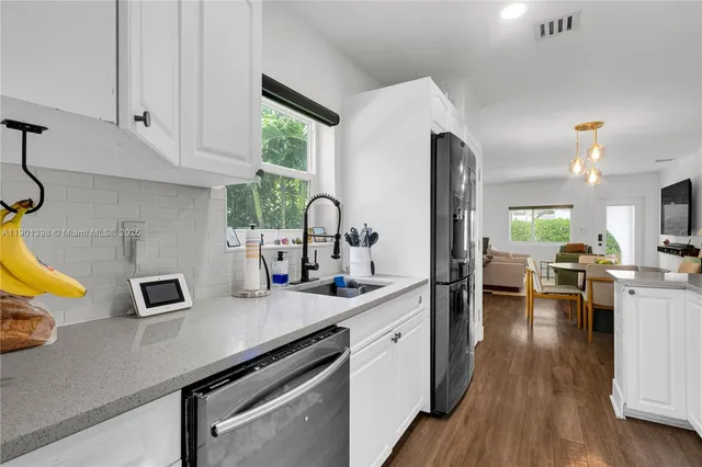 a kitchen with a sink appliances and cabinets
