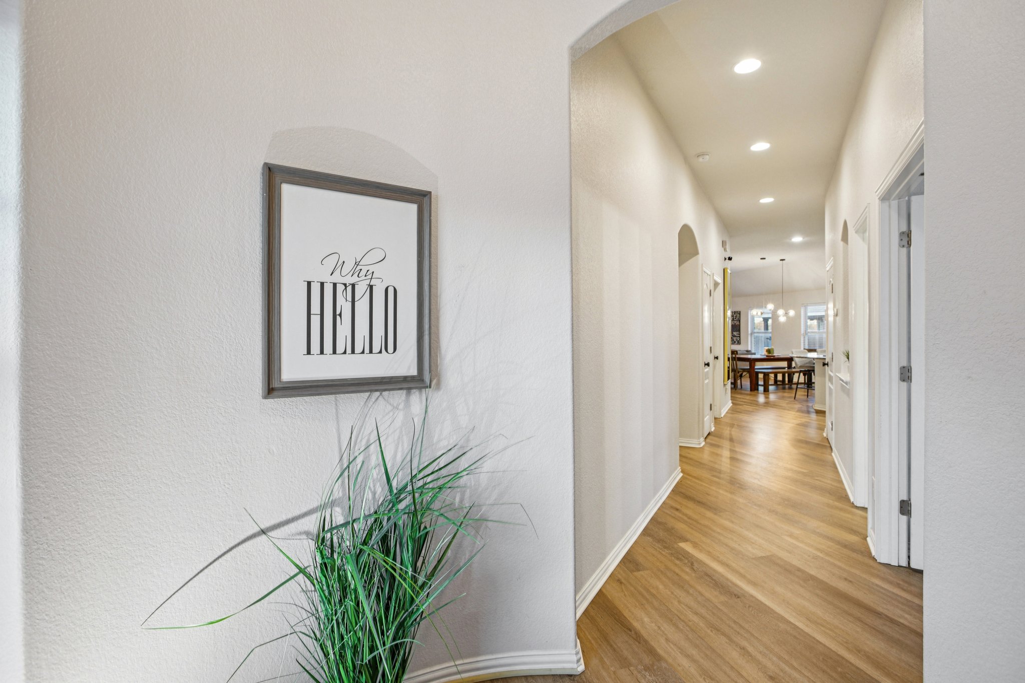 2308 Wind Vane West Pflugerville, TX 78660 - Photo 9 of 28 a view of a hallway with wooden floor and a potted plant