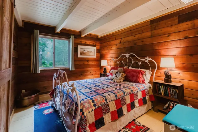 a bedroom with a bed next to a window