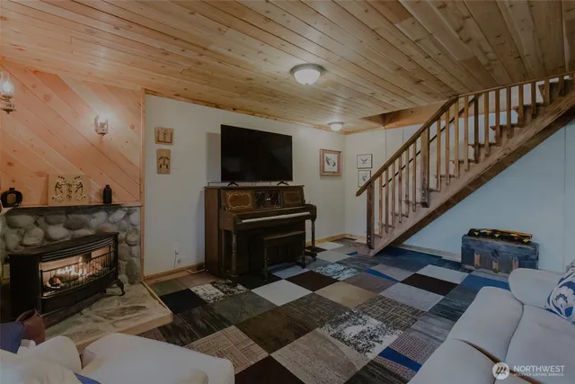 a living room with furniture a rug and a fireplace