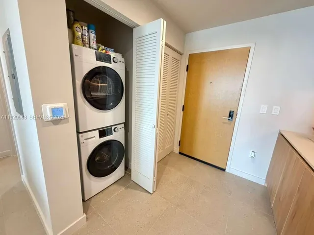 a view of a storage and utility room with washer and dryer