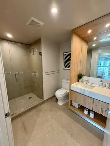 a bathroom with a double vanity sink toilet and shower