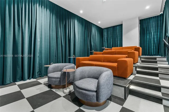 a bedroom with furniture and a large window