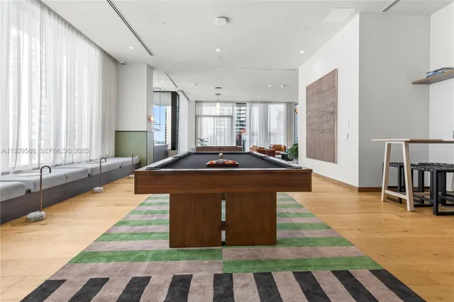 a living room with a gaming machine and a table