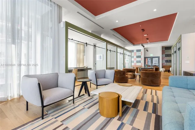 a living room with furniture a flat screen tv and a large window