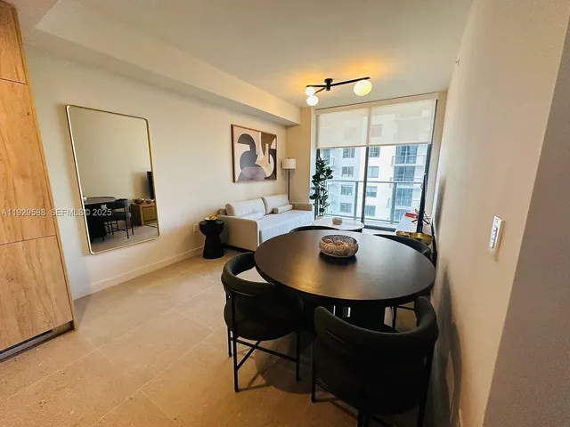 a view of a dining room with furniture and window