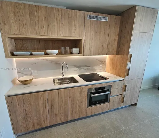 a kitchen with a stove and a sink