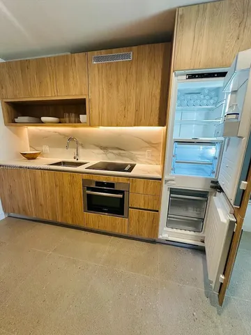 a kitchen with granite countertop a sink and a stove