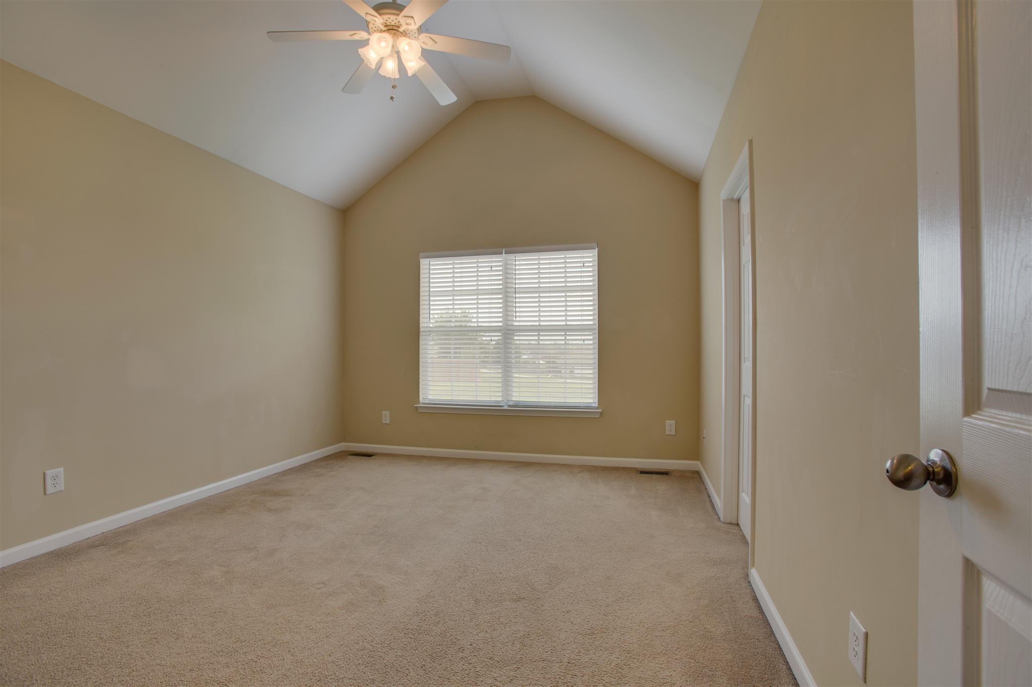 7039 Nickalus Way Spring Hill, TN 37174 - Photo 11 of 21 a view of a livingroom with a ceiling fan and window