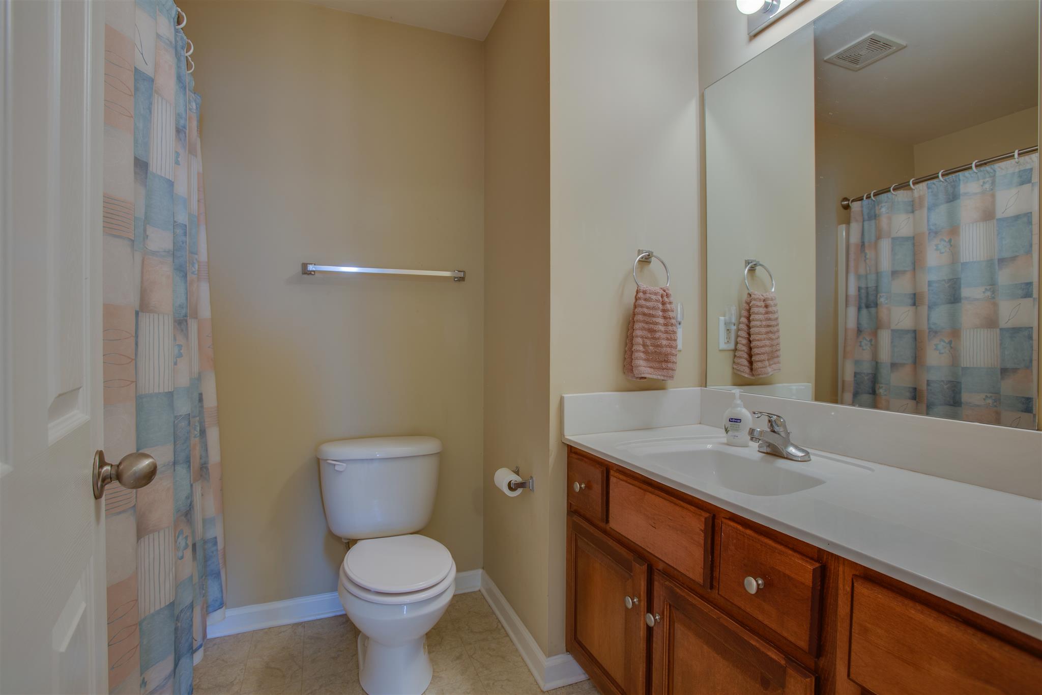 7039 Nickalus Way Spring Hill, TN 37174 - Photo 15 of 21 a bathroom with a granite countertop toilet sink and a mirror