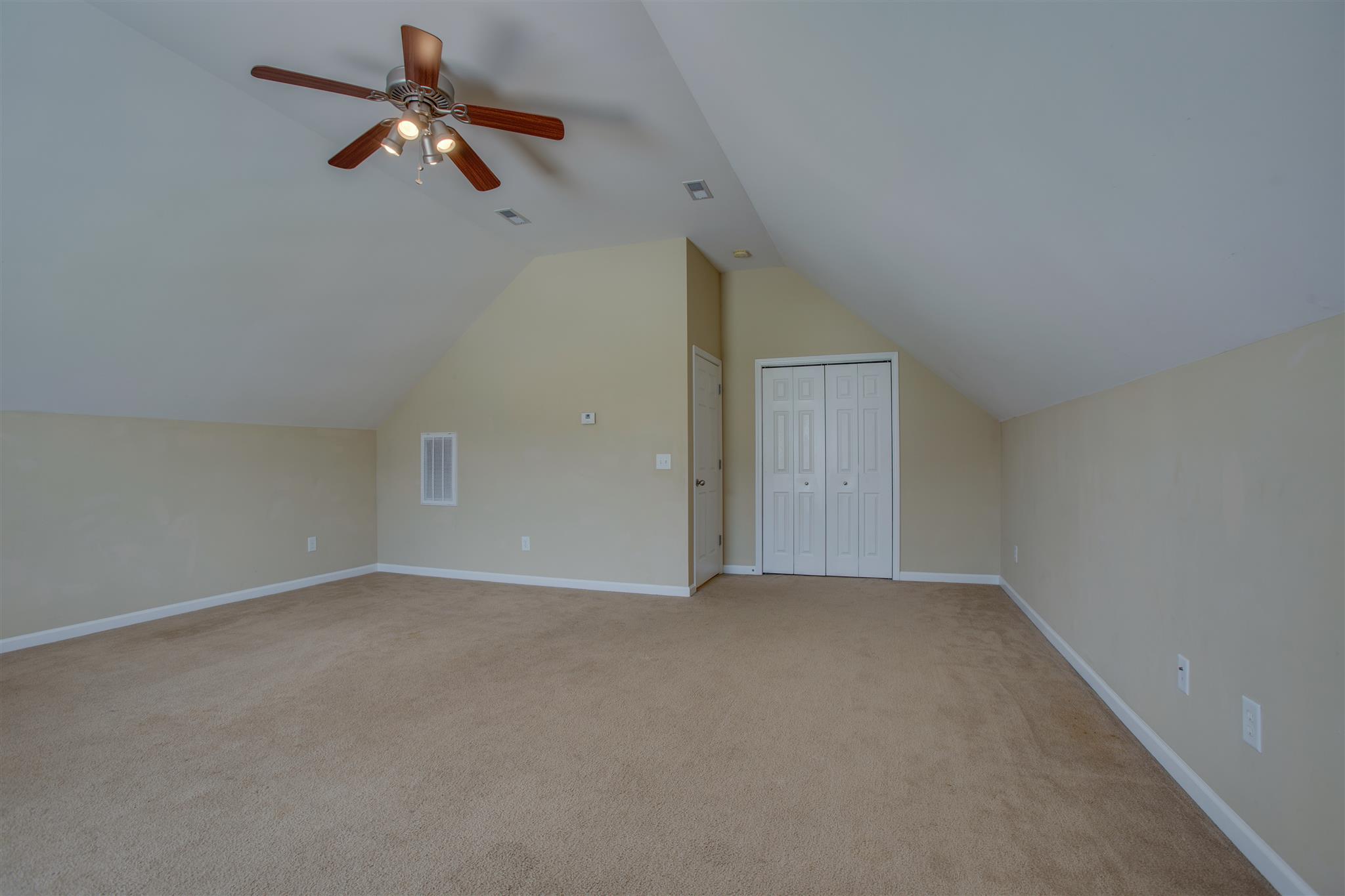 7039 Nickalus Way Spring Hill, TN 37174 - Photo 18 of 21 an empty room with ceiling fan and window