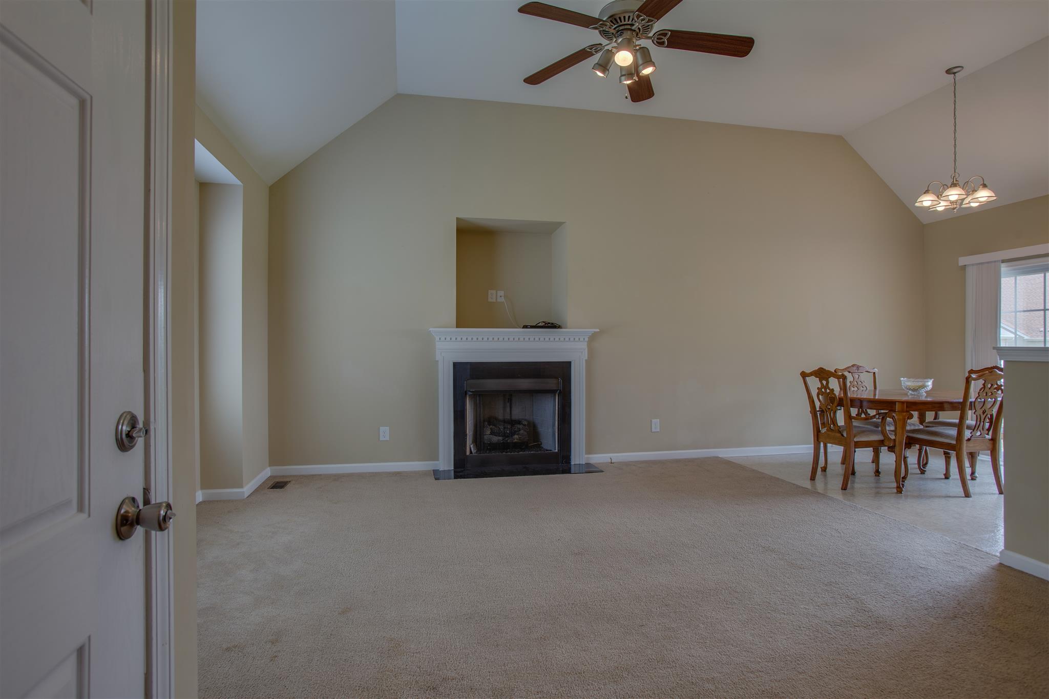 7039 Nickalus Way Spring Hill, TN 37174 - Photo 3 of 21 wooden floor and fireplace with windows