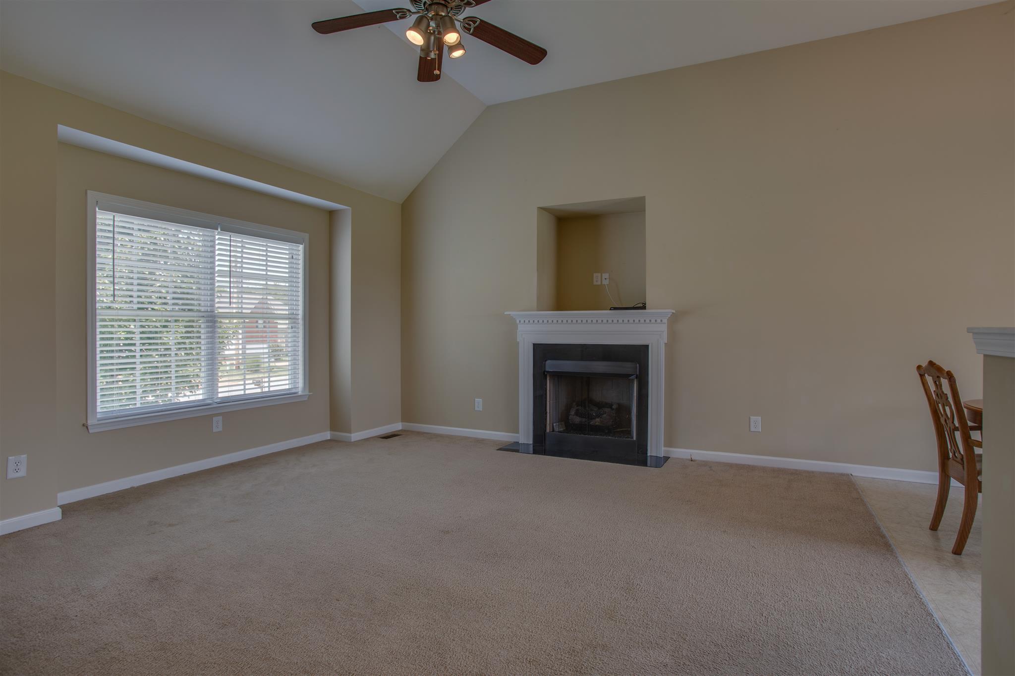 7039 Nickalus Way Spring Hill, TN 37174 - Photo 4 of 21 a view of empty room with a fireplace