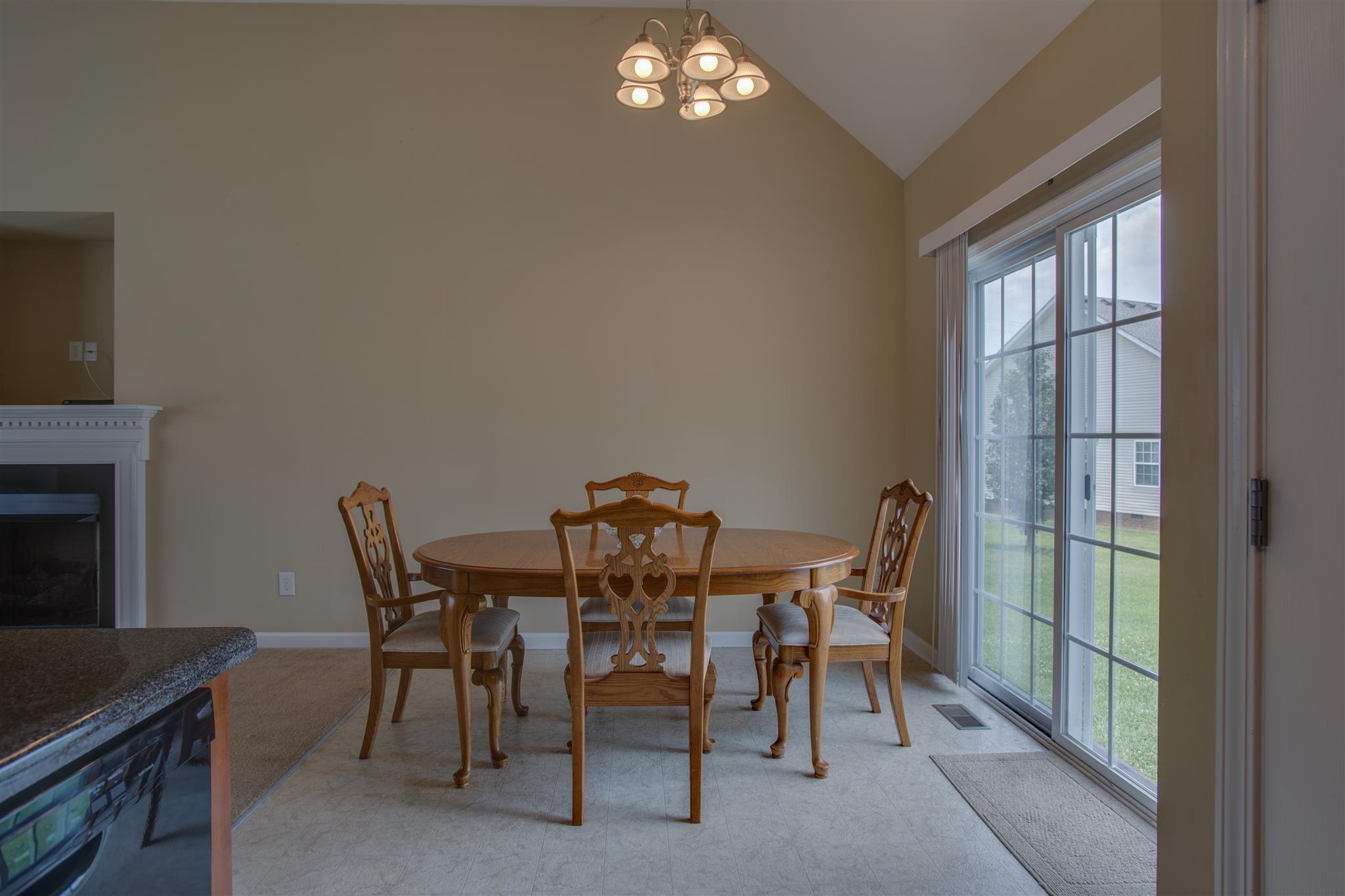 7039 Nickalus Way Spring Hill, TN 37174 - Photo 7 of 21 a view of a dining room with furniture and chandelier