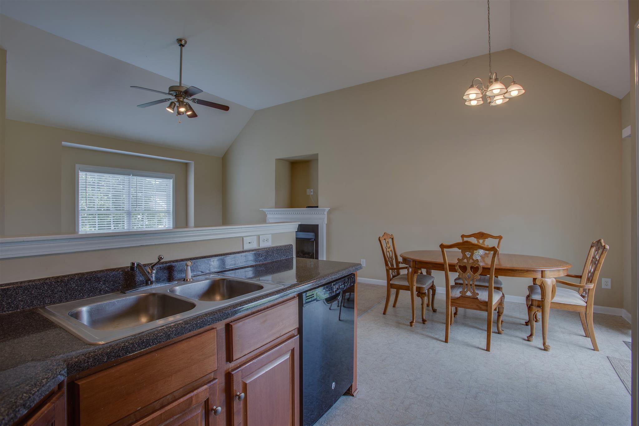 7039 Nickalus Way Spring Hill, TN 37174 - Photo 10 of 21 a kitchen with a dining table and chairs