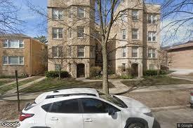 1615 Monroe Street, Unit 3N Evanston, IL 60202 - Photo 1 of 10 a white building that has a tree in front of it
