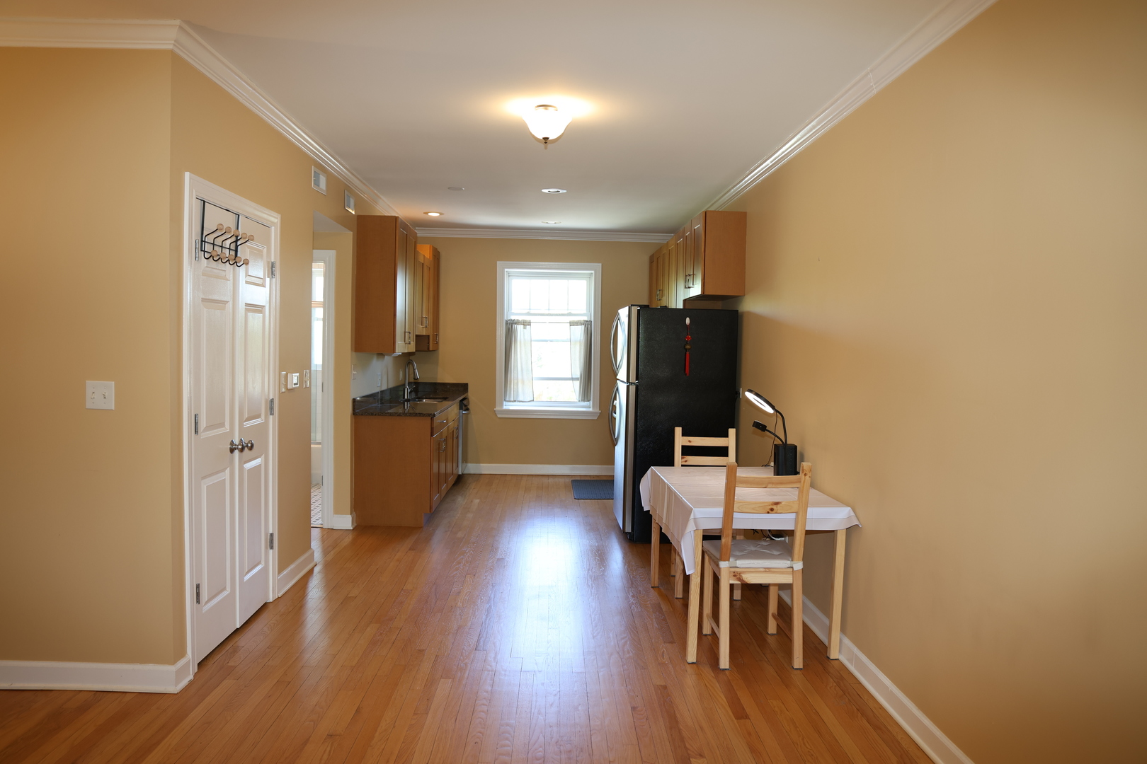 1615 Monroe Street, Unit 3N Evanston, IL 60202 - Photo 2 of 10 a view of a kitchen with furniture and wooden floor