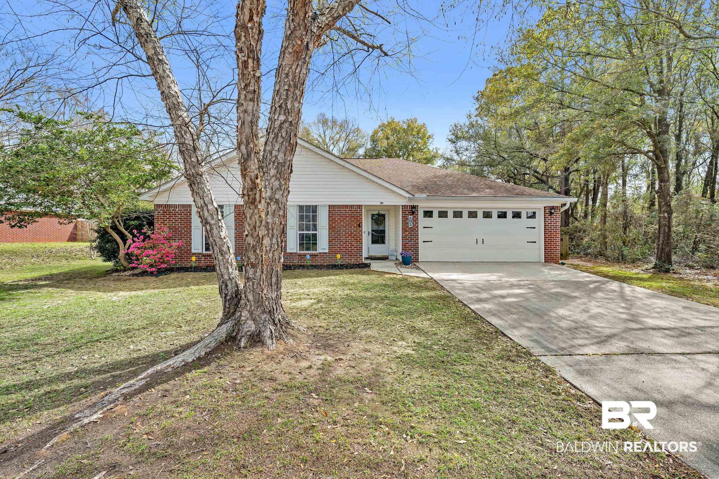 191 Robbins Boulevard Daphne, AL 36526 - Photo 1 of 24 Ranch-style house featuring concrete driveway, brick siding, a front yard, and an attached garage
