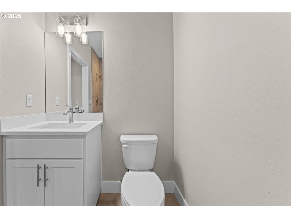 9824 Southwest 34th Place Portland, OR 97219 - Photo 14 of 19 a bathroom with a toilet a sink and mirror