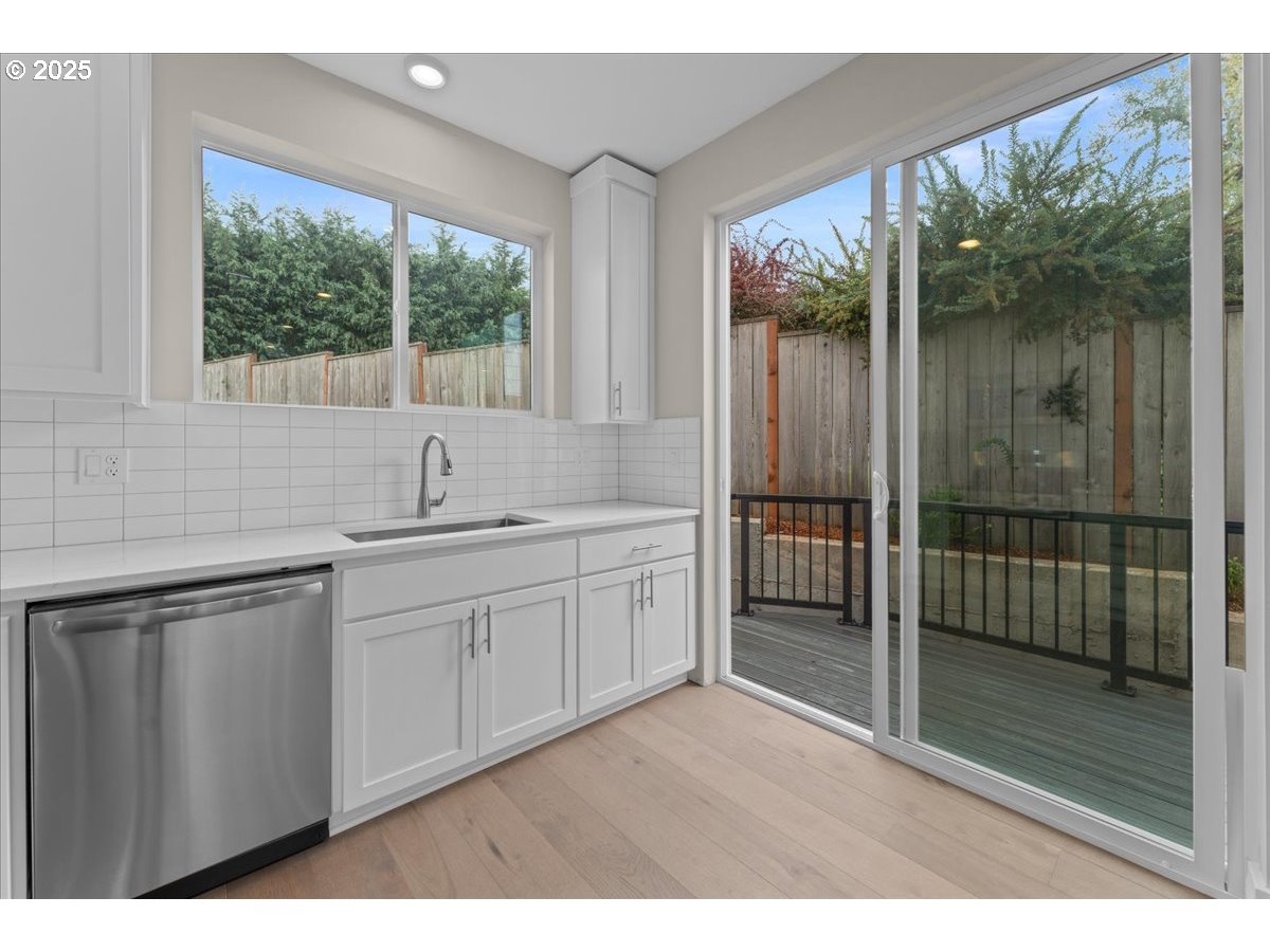 9824 Southwest 34th Place Portland, OR 97219 - Photo 6 of 19 a bathroom with a double vanity sink and mirror