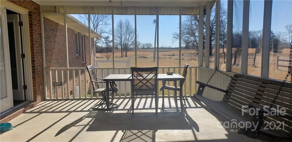 650 Monticello Road Lancaster, SC 29720 - Photo 20 of 25 a view of a patio with table and chairs and wooden floor