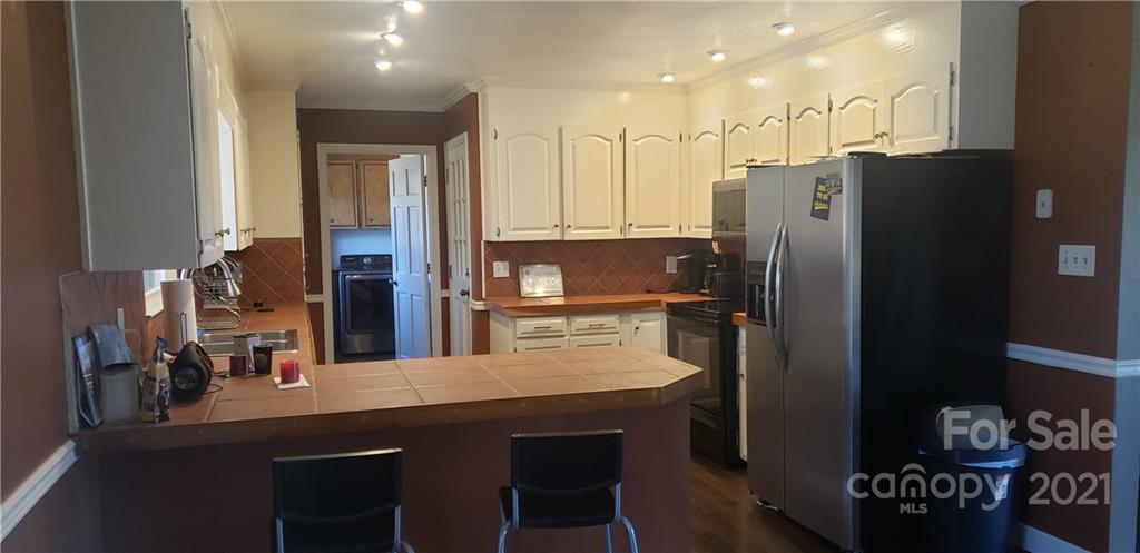 650 Monticello Road Lancaster, SC 29720 - Photo 4 of 25 a kitchen with stainless steel appliances granite countertop a refrigerator and a stove