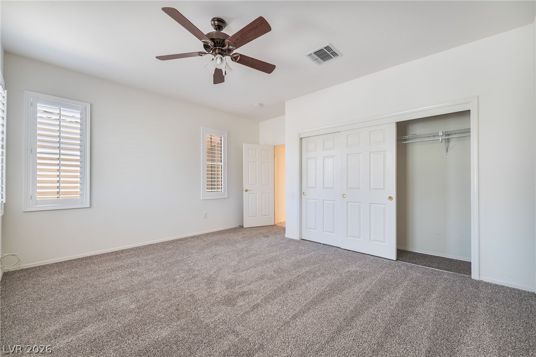 3033 Hartsville Road Henderson, NV 89052 - Photo 33 of 41 A comfortable bedroom with plush carpeting features ample closet space and natural light.