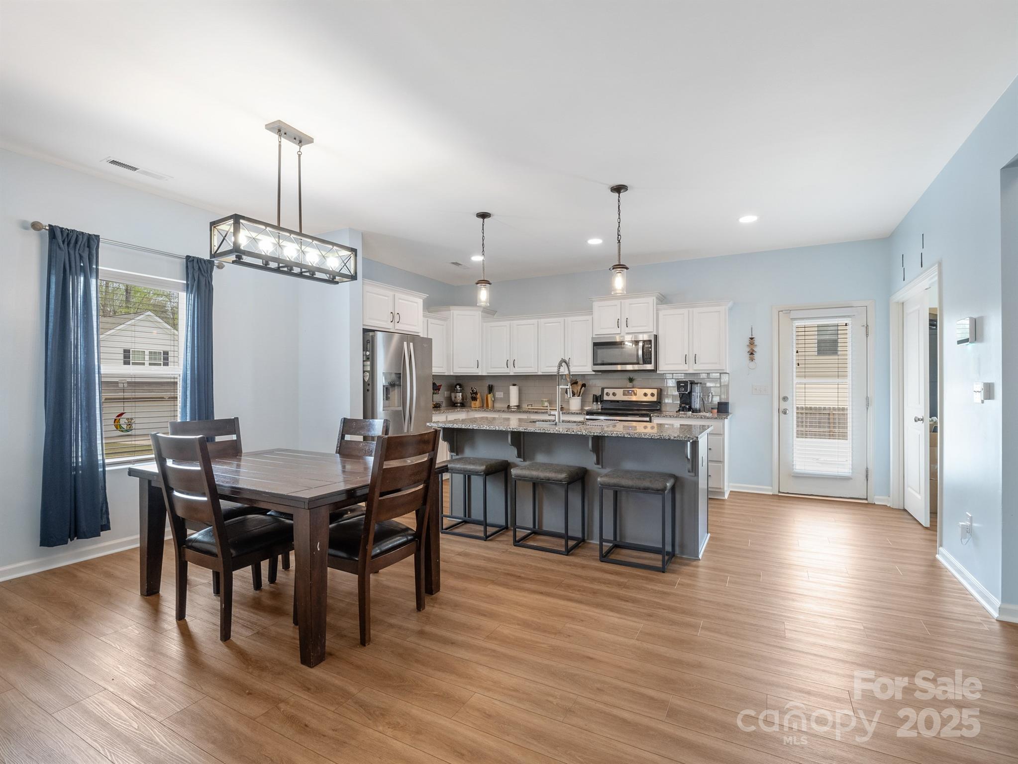 629 Gants Road York, SC 29745 - Photo 3 of 28 a view of a dining room and livingroom with furniture wooden floor a chandelier