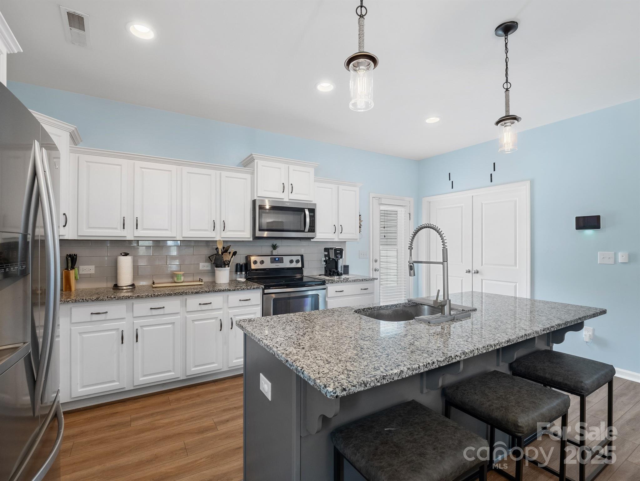 629 Gants Road York, SC 29745 - Photo 6 of 28 a kitchen with kitchen island granite countertop a table chairs sink and cabinets