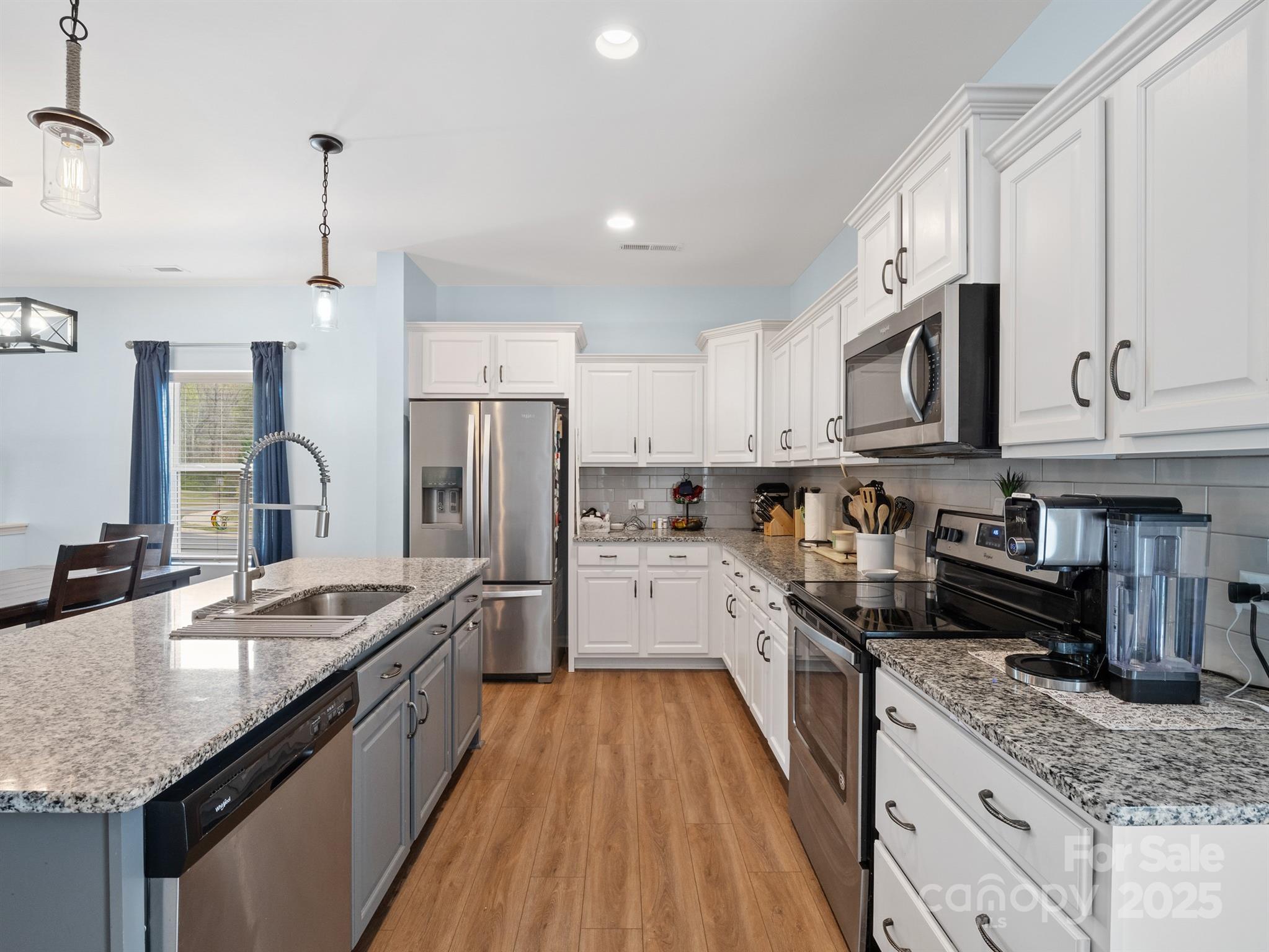 629 Gants Road York, SC 29745 - Photo 7 of 28 a large kitchen with granite countertop a sink dishwasher a stove top oven a refrigerator with cabinets and wooden floor