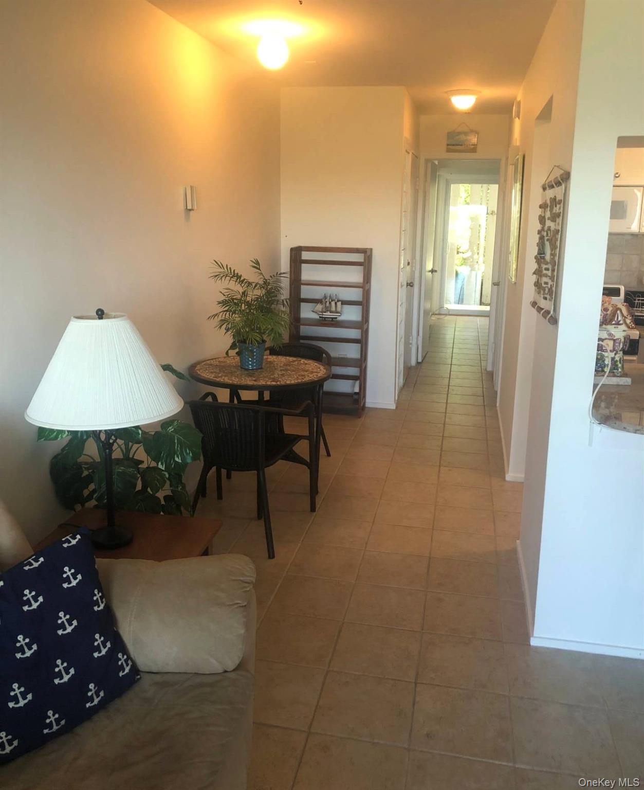 274 Dune Road Westhampton Beach, NY 11978 - Photo 4 of 14 a workspace with furniture and a lamp