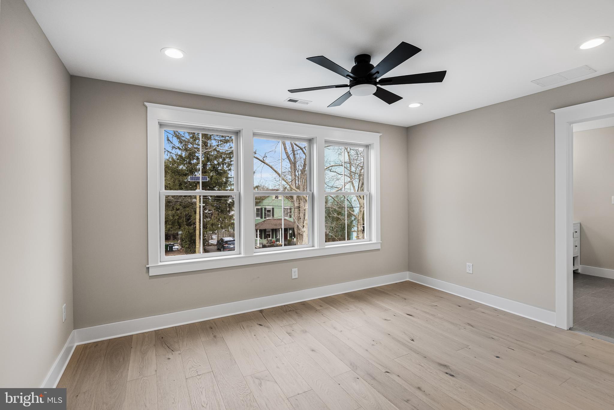 301 Centre Street Haddonfield, NJ 08033 - Photo 43 of 64 an empty room with wooden floor fan and windows