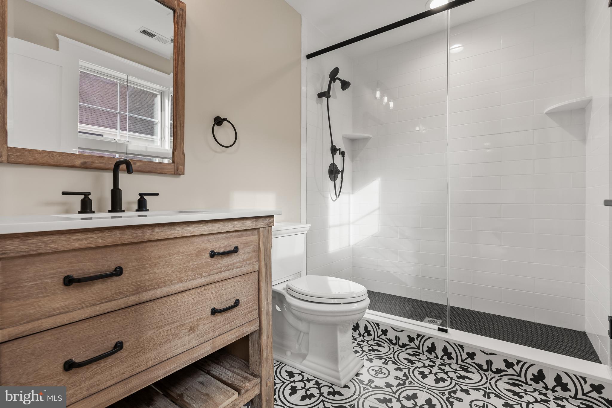 301 Centre Street Haddonfield, NJ 08033 - Photo 50 of 64 a bathroom with a sink a toilet a shower and a mirror