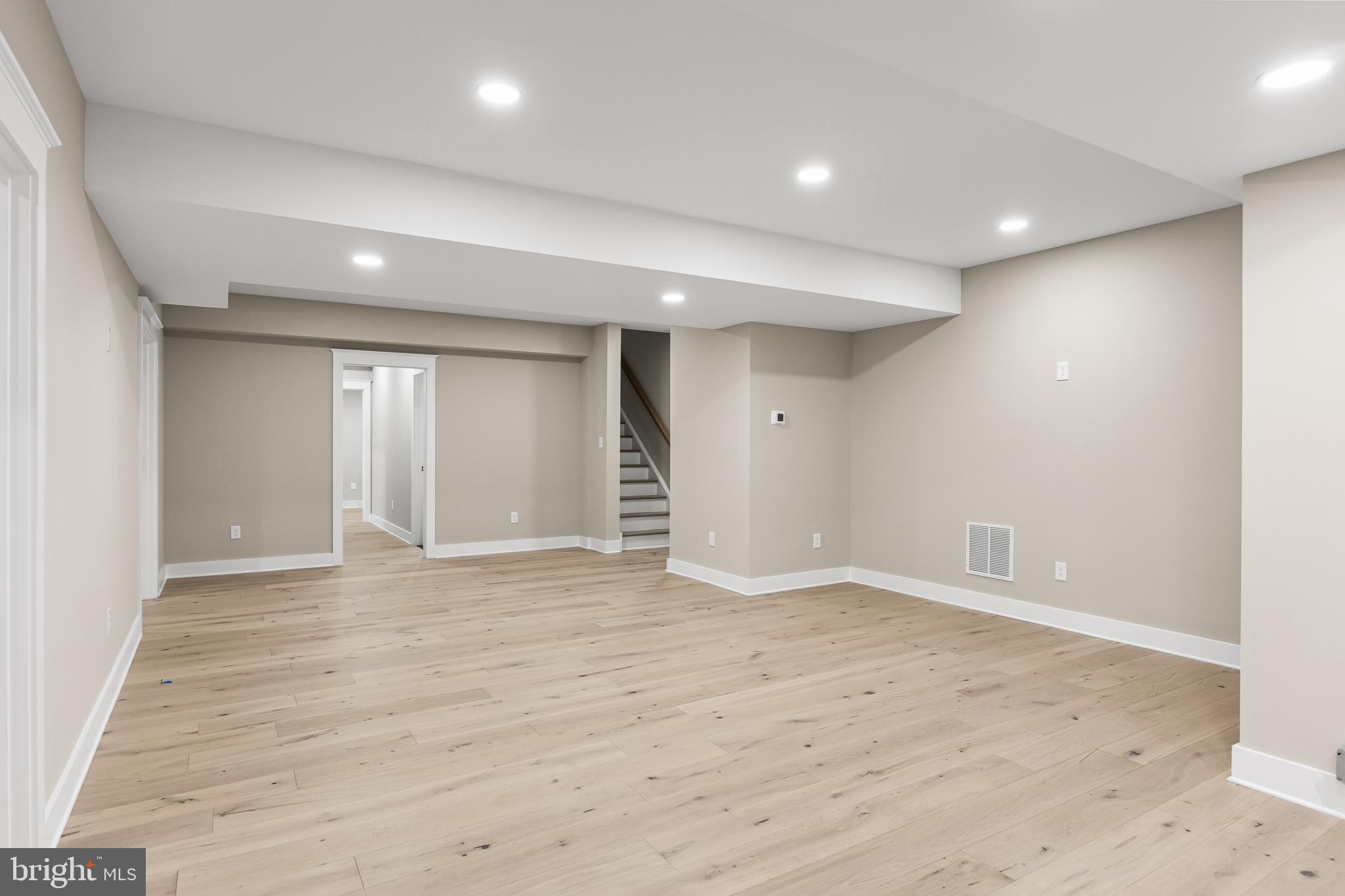 301 Centre Street Haddonfield, NJ 08033 - Photo 56 of 64 an empty room with wooden floor and windows