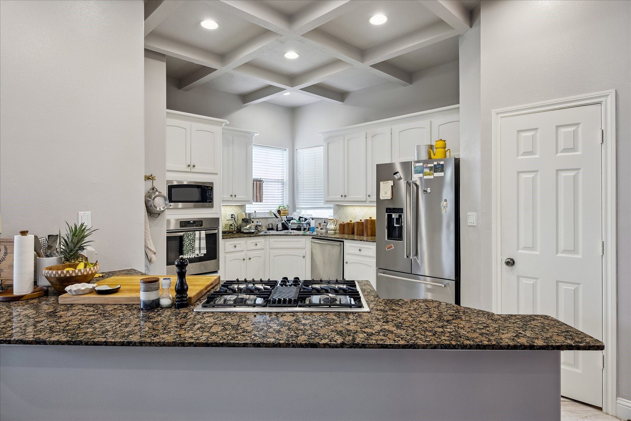 1304 Dart Street, Unit F Houston, TX 77007 - Photo 5 of 13 a kitchen with stainless steel appliances granite countertop a refrigerator a stove and a sink