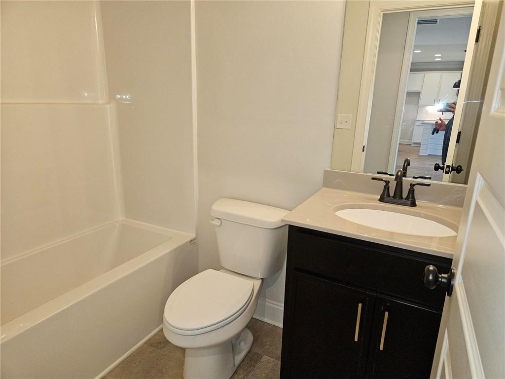 440 Banff Drive Winder, GA 30680 - Photo 15 of 18 a bathroom with a sink a toilet and shower